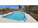 Sparkling community pool with clear blue water, lounge chairs, and lush landscaping at 7910 E Thomas Rd # 118, Scottsdale, AZ 85251