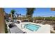 Relaxing hot tub with a built-in BBQ, stone patio, and comfortable lounge chairs at 7910 E Thomas Rd # 118, Scottsdale, AZ 85251