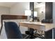 Stylish home office features a wooden desk, chair, and modern lamp at 7920 E Arlington Rd # 2, Scottsdale, AZ 85250