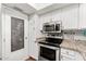 Stainless steel appliances and granite countertops in this well-lit kitchen at 7920 E Arlington Rd # 2, Scottsdale, AZ 85250