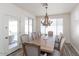 Elegant dining room with a rustic wooden table and chandelier at 862 E Gemini Pl, Chandler, AZ 85249