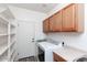 Laundry room with washer, dryer, cabinets, and extra shelving at 862 E Gemini Pl, Chandler, AZ 85249