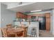 Small dining area with wood table and chairs near kitchen at 8787 E Mountain View Rd # 2101, Scottsdale, AZ 85258