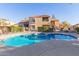 Kidney shaped pool and spa with lounge chairs at 8787 E Mountain View Rd # 2101, Scottsdale, AZ 85258