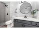 Updated bathroom with gray tile, marble accents, and a large mirror at 8802 E University Dr # 66, Mesa, AZ 85207