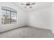 Spacious bedroom with ceiling fan, carpet flooring, and large window at 8802 E University Dr # 66, Mesa, AZ 85207