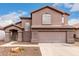 Two-story house with a brown exterior, attached garage, and landscaping at 8802 E University Dr # 66, Mesa, AZ 85207