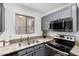 Modern kitchen with gray cabinets and stainless steel appliances at 8802 E University Dr # 66, Mesa, AZ 85207