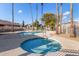 Community pool and spa with palm trees and surrounding homes at 8802 E University Dr # 66, Mesa, AZ 85207