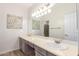 Double vanity bathroom with updated light fixtures at 8833 W Tierra Buena Ln, Peoria, AZ 85382