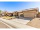 One-story home with tan exterior and two-car garage at 8833 W Tierra Buena Ln, Peoria, AZ 85382