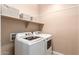 Laundry room with washer, dryer, and shelving at 8833 W Tierra Buena Ln, Peoria, AZ 85382