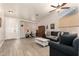 Relaxing living room with hardwood floors, ceiling fan, and comfy seating at 8833 W Tierra Buena Ln, Peoria, AZ 85382