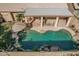 An aerial view of a kidney-shaped pool with a patio and covered seating area at 8833 W Tierra Buena Ln, Peoria, AZ 85382