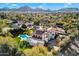 Aerial view of a luxurious home with pool, spa, and expansive backyard, set against a scenic mountain backdrop at 8915 N Invergordon Rd, Paradise Valley, AZ 85253