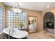 Bathroom with freestanding tub, large mirror, and glass block window at 8915 N Invergordon Rd, Paradise Valley, AZ 85253