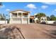 Two-story home with attached two-car garage, balconies, and Spanish-style architectural details at 8915 N Invergordon Rd, Paradise Valley, AZ 85253