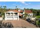 Spanish-style home with red tile roof, large garage, and mature landscaping at 8915 N Invergordon Rd, Paradise Valley, AZ 85253