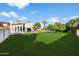 Expansive grassy lawn with mature trees and a view of the house at 8915 N Invergordon Rd, Paradise Valley, AZ 85253