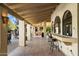 Outdoor patio with seating, adjacent to pool and built-in barbeque at 8915 N Invergordon Rd, Paradise Valley, AZ 85253