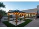 Backyard patio with a pergola, fire pit, and artificial turf at 9439 E Palm Tree Dr, Scottsdale, AZ 85255