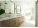 Modern bathroom with double vanity and a large soaking tub at 9439 E Palm Tree Dr, Scottsdale, AZ 85255