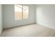 Simple bedroom with light walls and wood-look floors at 9439 E Palm Tree Dr, Scottsdale, AZ 85255