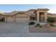 Single-story home with a two-car garage and desert landscaping at 9439 E Palm Tree Dr, Scottsdale, AZ 85255