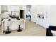 Bright kitchen featuring a waterfall island, stainless steel appliances, and white cabinets at 9439 E Palm Tree Dr, Scottsdale, AZ 85255