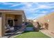 Inviting backyard space with covered patio, comfortable seating, artificial grass and desert landscaping at 9970 E Monte Cristo Ave, Scottsdale, AZ 85260