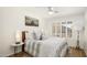 Cozy bedroom with wood floors, neutral bedding, and ample natural light at 9970 E Monte Cristo Ave, Scottsdale, AZ 85260