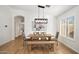 Bright dining room featuring wood floors, modern lighting, and neutral decor open to kitchen at 9970 E Monte Cristo Ave, Scottsdale, AZ 85260