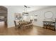 Bright dining room with wood floors, modern lighting, and neutral decor open to living area at 9970 E Monte Cristo Ave, Scottsdale, AZ 85260