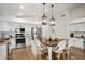 Bright open kitchen featuring a large island, pendant lighting, and stainless steel appliances at 9970 E Monte Cristo Ave, Scottsdale, AZ 85260