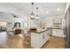 Open concept kitchen with a large island, white cabinetry, and stainless steel appliances at 9970 E Monte Cristo Ave, Scottsdale, AZ 85260