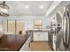 Well-lit kitchen with stainless steel appliances, white cabinets, and a large island at 9970 E Monte Cristo Ave, Scottsdale, AZ 85260