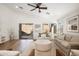 Bright living room featuring neutral decor, wood flooring, and large windows at 9970 E Monte Cristo Ave, Scottsdale, AZ 85260