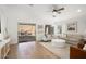 Bright living room with sliding glass doors to patio, neutral decor, and wood flooring at 9970 E Monte Cristo Ave, Scottsdale, AZ 85260