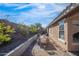 Charming side yard featuring a dining table set, gravel landscaping, and a raised garden, creating a cozy outdoor space at 9970 E Monte Cristo Ave, Scottsdale, AZ 85260