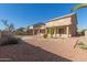 Landscaped backyard with gravel, cactus plants, and a two-story house at 10325 W Windsor Ave, Avondale, AZ 85392