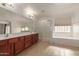 Elegant bathroom with double sinks, soaking tub, and shower at 10325 W Windsor Ave, Avondale, AZ 85392