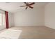 Spacious bedroom with ceiling fan and window at 10325 W Windsor Ave, Avondale, AZ 85392