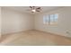 Bright bedroom with ceiling fan and carpeting at 10325 W Windsor Ave, Avondale, AZ 85392