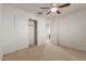 Bright bedroom with ceiling fan and closet at 10325 W Windsor Ave, Avondale, AZ 85392