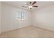 Spacious bedroom with ceiling fan and window at 10325 W Windsor Ave, Avondale, AZ 85392