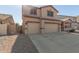 Two-story house with a three-car garage and gated entry at 10325 W Windsor Ave, Avondale, AZ 85392