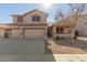 Two-story house with a three-car garage and desert landscaping at 10325 W Windsor Ave, Avondale, AZ 85392