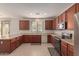 L-shaped kitchen with stainless steel appliances and wood cabinets at 10325 W Windsor Ave, Avondale, AZ 85392