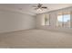 Spacious living room with large windows and ceiling fan at 10325 W Windsor Ave, Avondale, AZ 85392