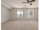 Spacious living room with large windows and ceiling fan at 10325 W Windsor Ave, Avondale, AZ 85392